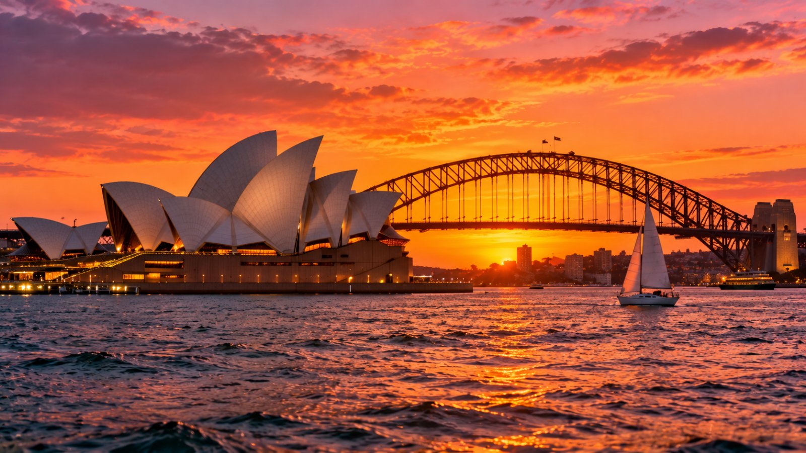 La Sydney Opera House e l'Harbour Bridge sul porto di Sydney, nella luce del tramonto